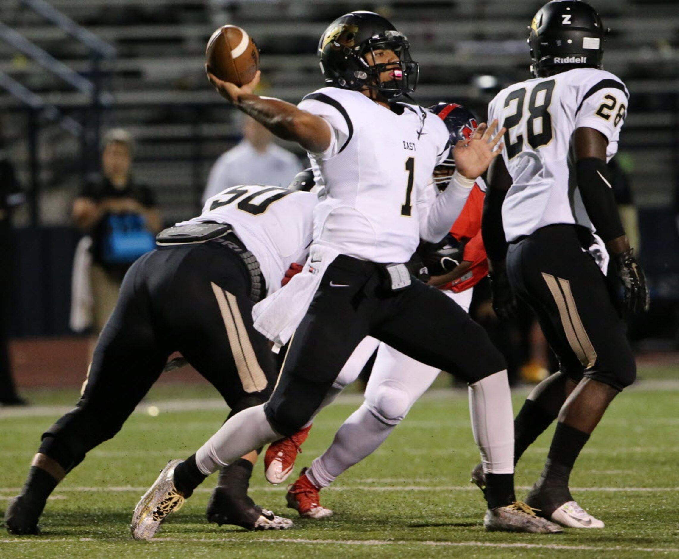 Plano East quarterback Miklo Smalls (1) throws the ball in the second quarter during a high...