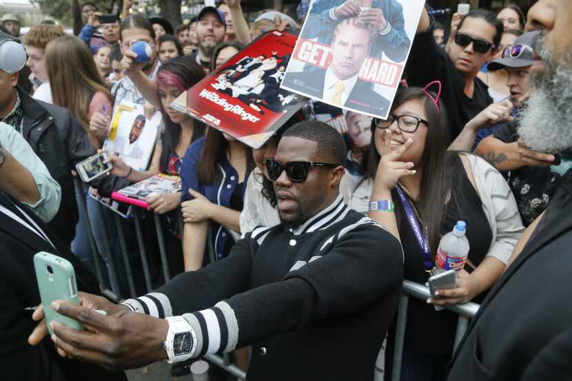 Kevin Hart poses with fans after arriving for the world premiere of "Get Hard" during the...
