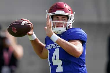 Oklahoma quarterback General Booty throws during an NCAA college football practice, Monday,...