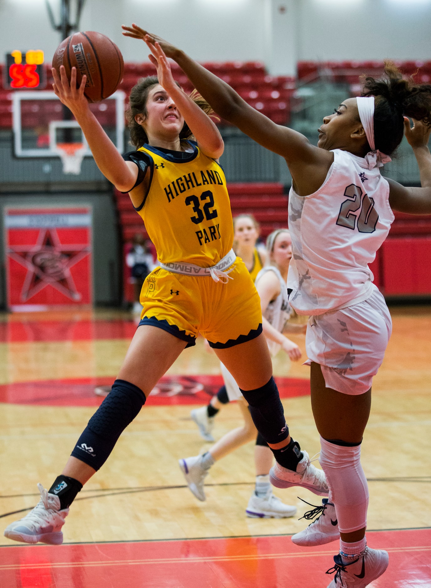 Highland Park forward Madison Visinsky (32) goes up for a shot against Frisco Lone Star...