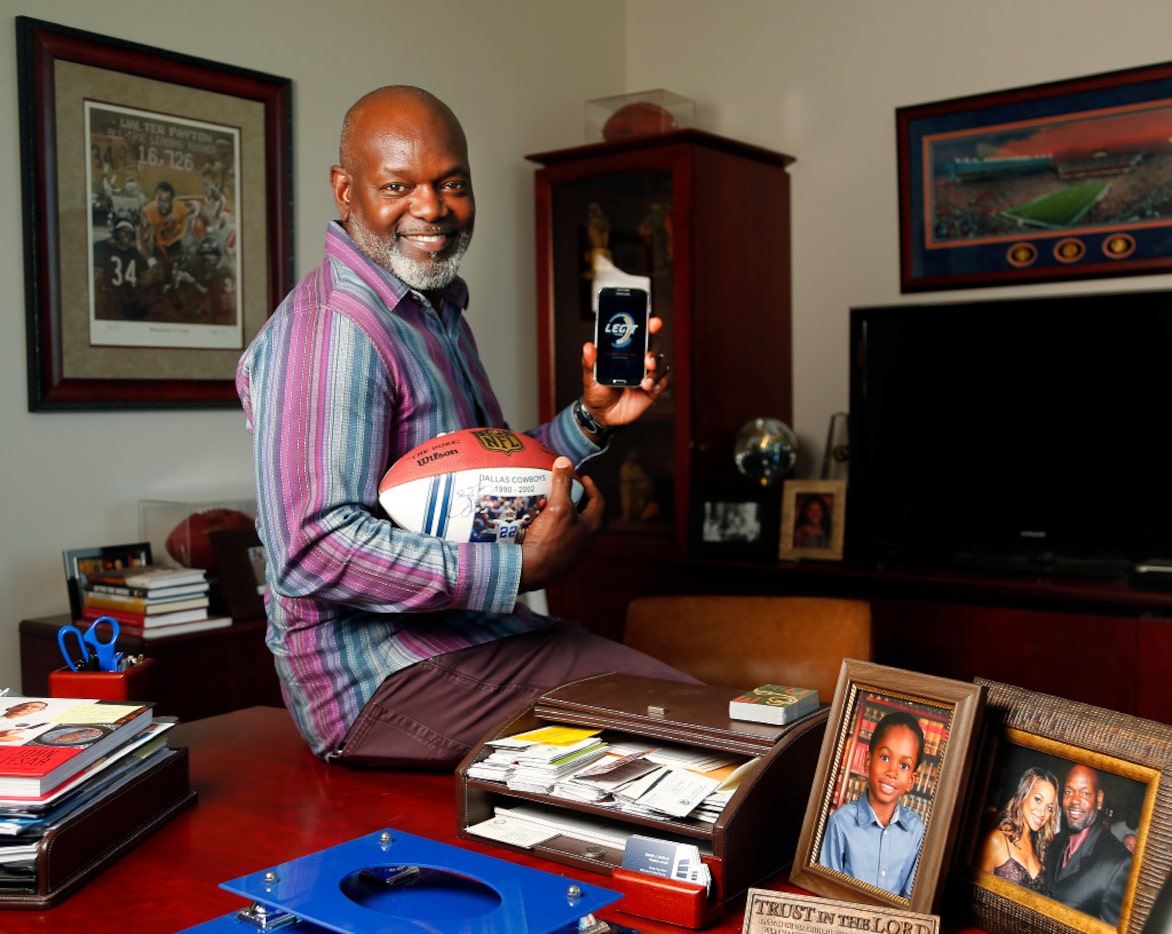 Dallas Cowboys Hall of Fame running back Emmitt Smith shows his football embedded with a...