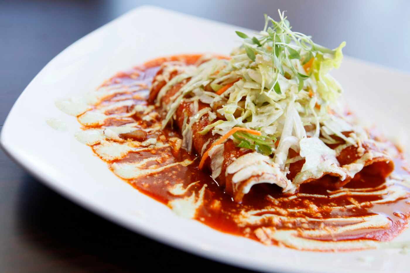Enchiladas rojas with guajillo, queso fresco is among featured items at Cafe Herrera...