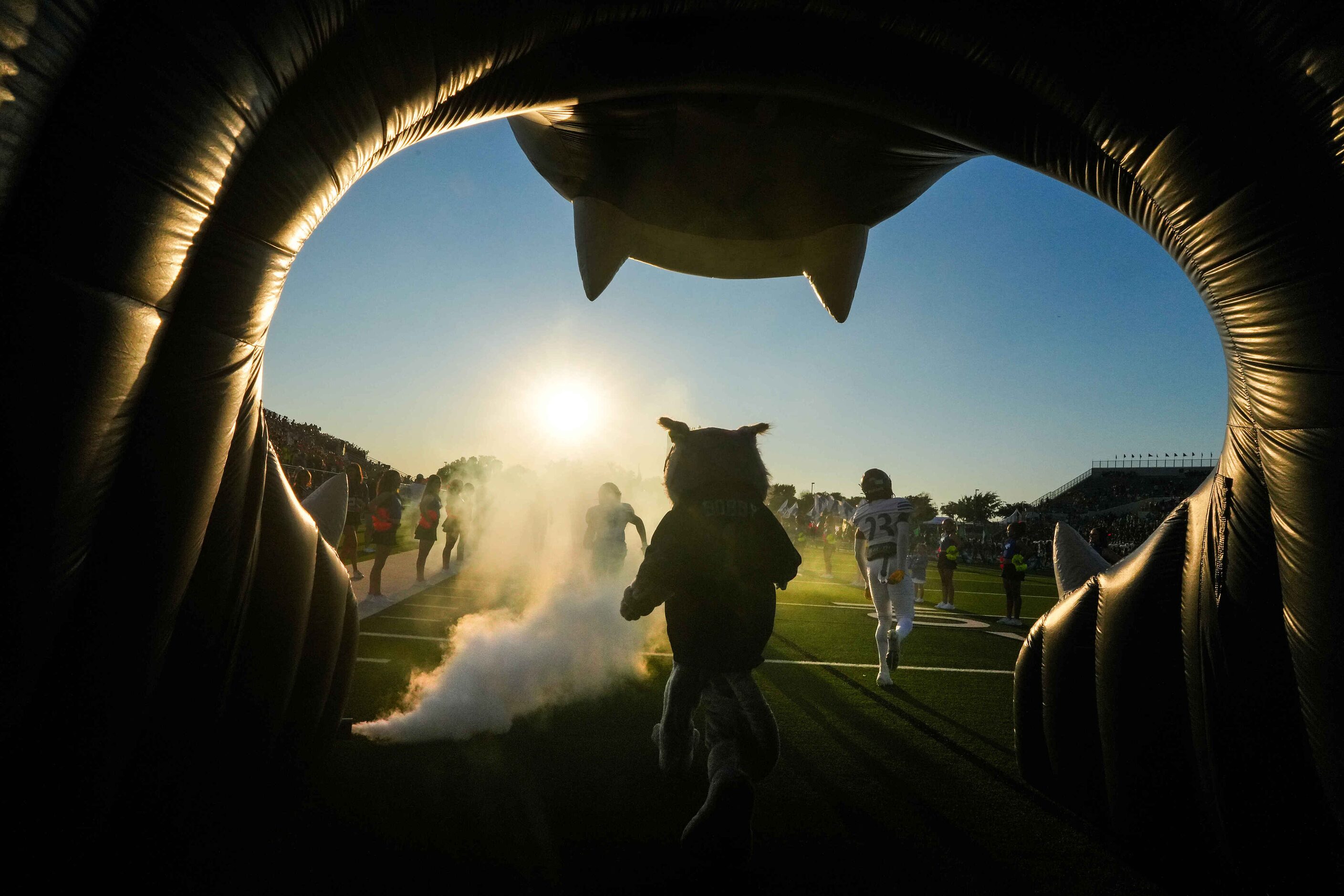 The Trophy Club Byron Nelson Bobcat mascot follows the team from the tunnel as they take the...