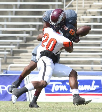 Rockwell defensive back Anfernee Orji (20) jars the ball loose from Rowlett receiver Donald...