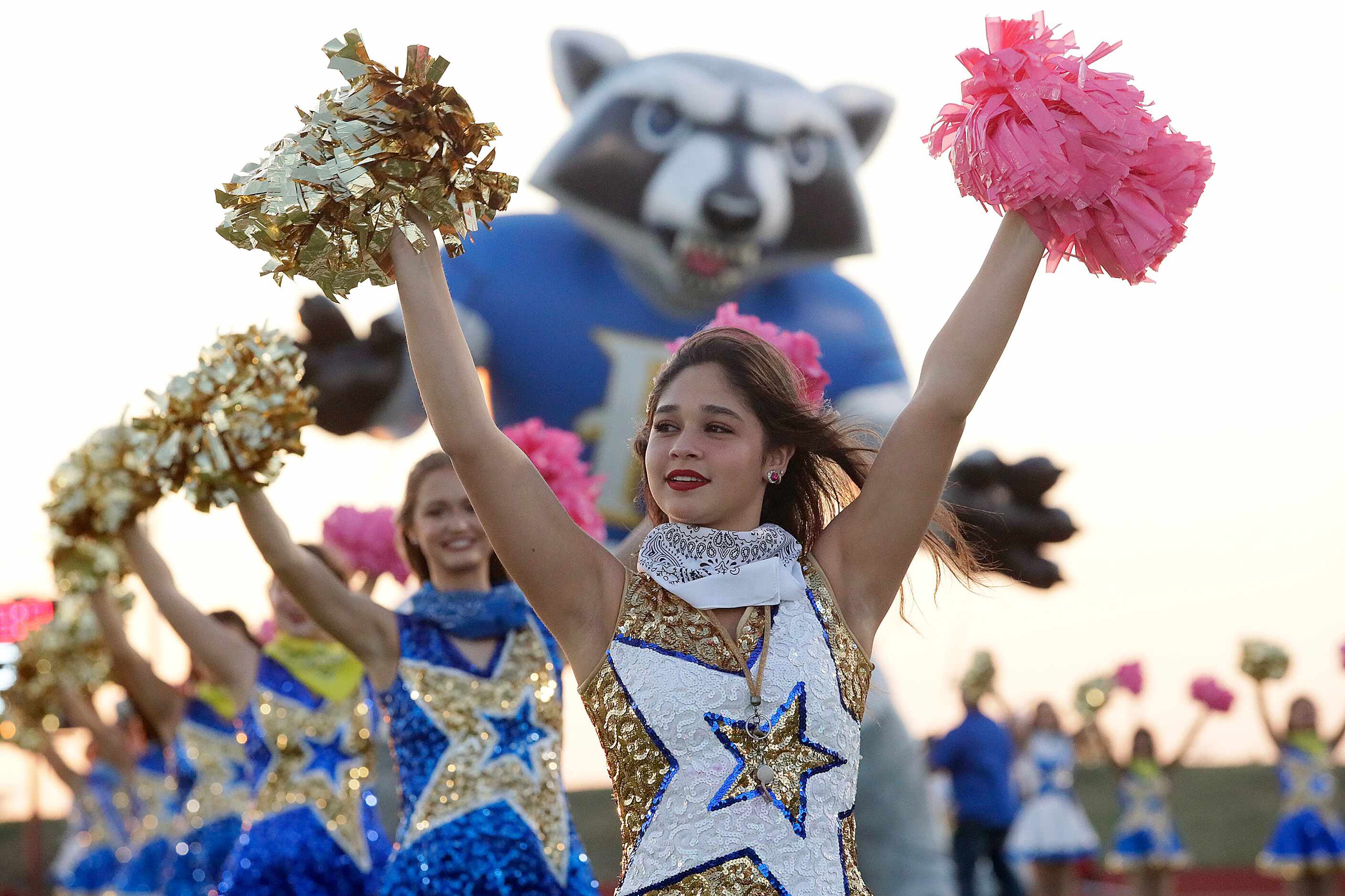 Kate Gomez, 17, with the Frisco High School Stars Drill Team, performs before kickoff  as...