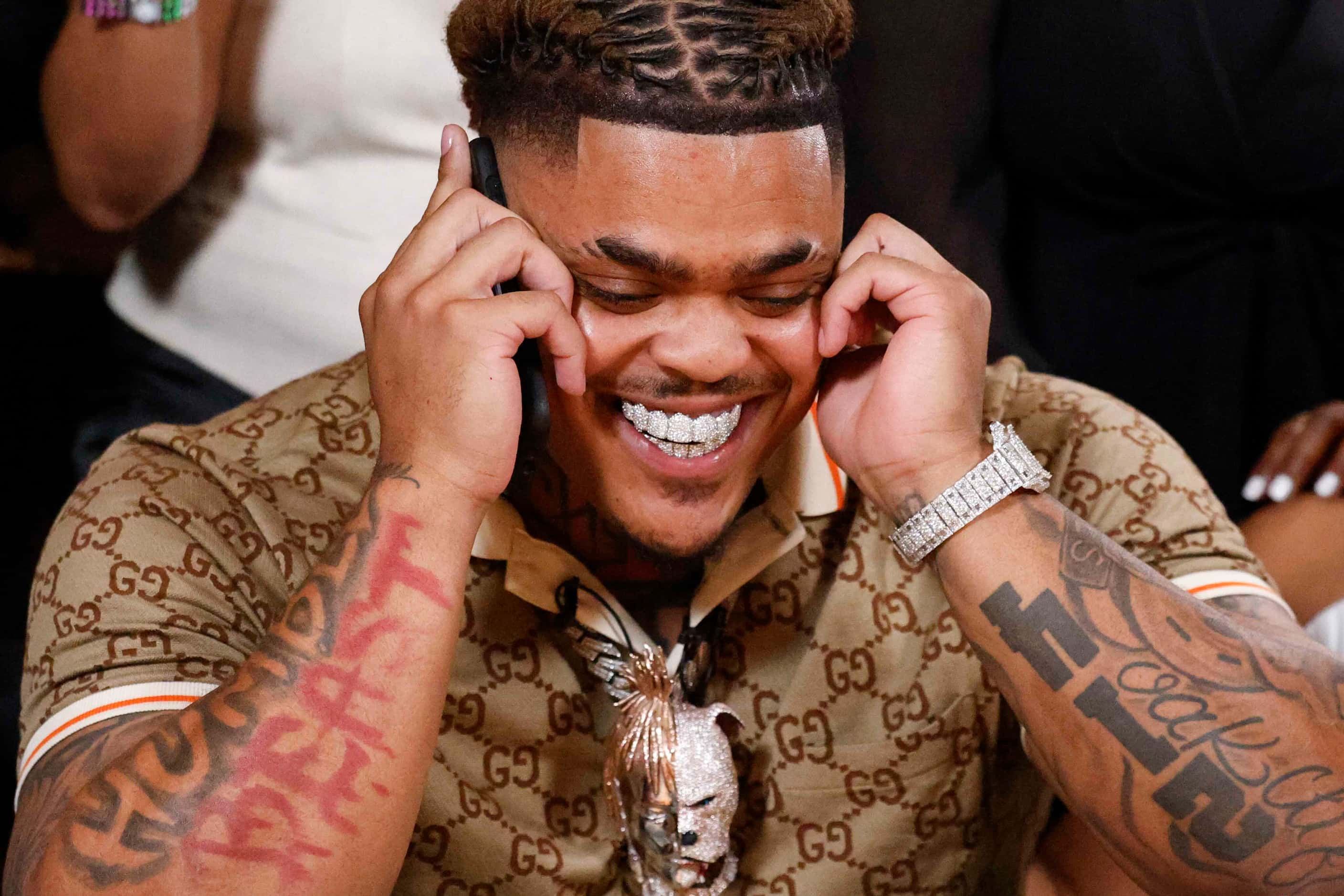 Texas defensive tackle Byron Murphy II, from DeSoto, reacts as he takes a phone call before...