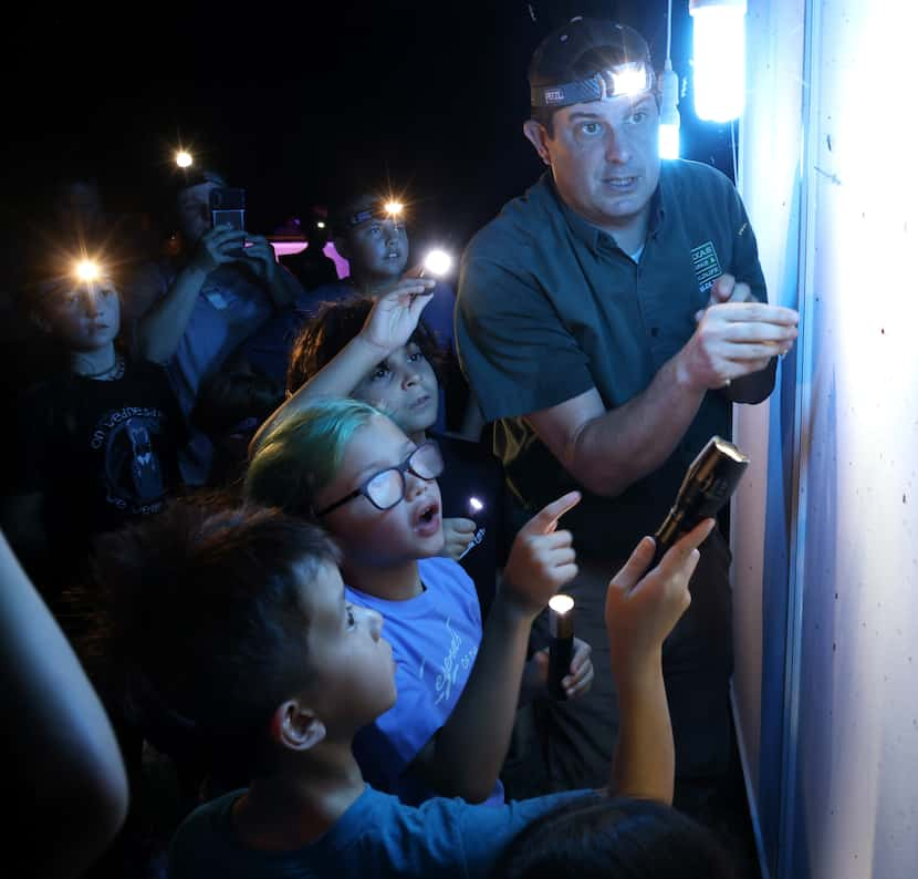 Sam Kieschnick, upper right, of the Texas Department of Wildlife, accompanies young area...