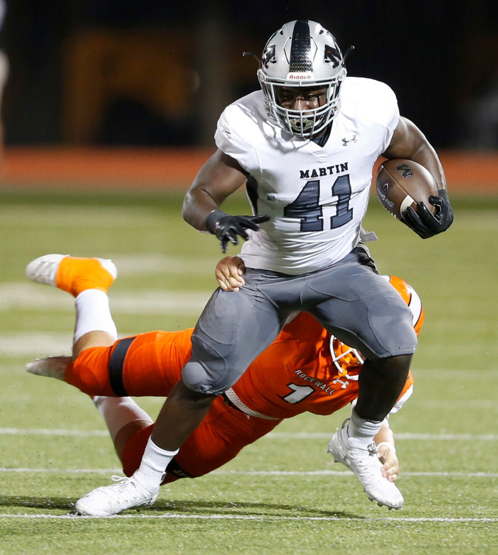 Arlington Martin's Chris Craft (41) is tackled by Rockwall's Gage Elder (1) during the first...