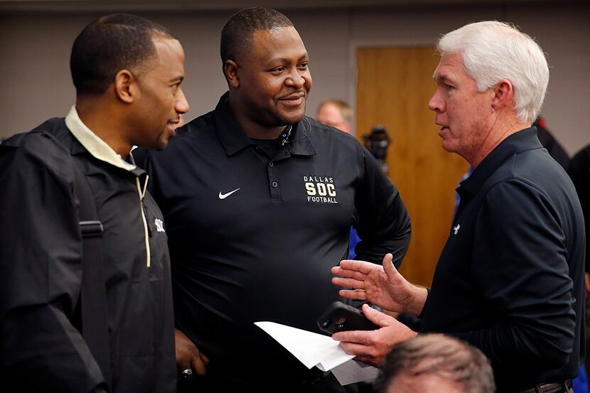 Southlake Carroll head football coach Hal Wasson, right, visits with South Oak Cliff head...