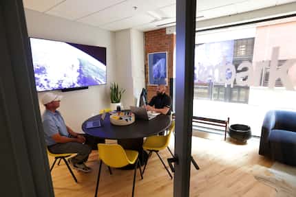 Clancy Fossum, left, and Paul Allen work in their office space at the West End area Common...