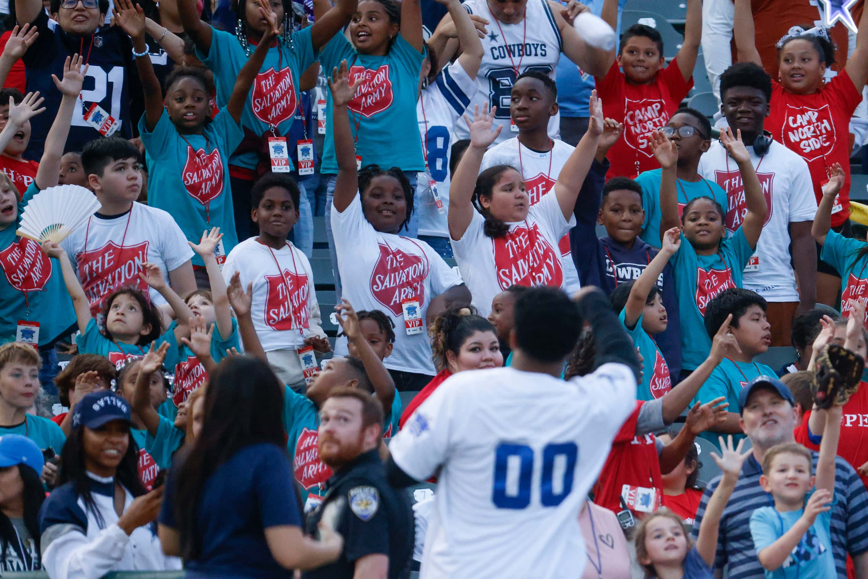 Fans reacts towards Dallas Cowboys running back Ezekiel Elliott as he throws t-shirts during...