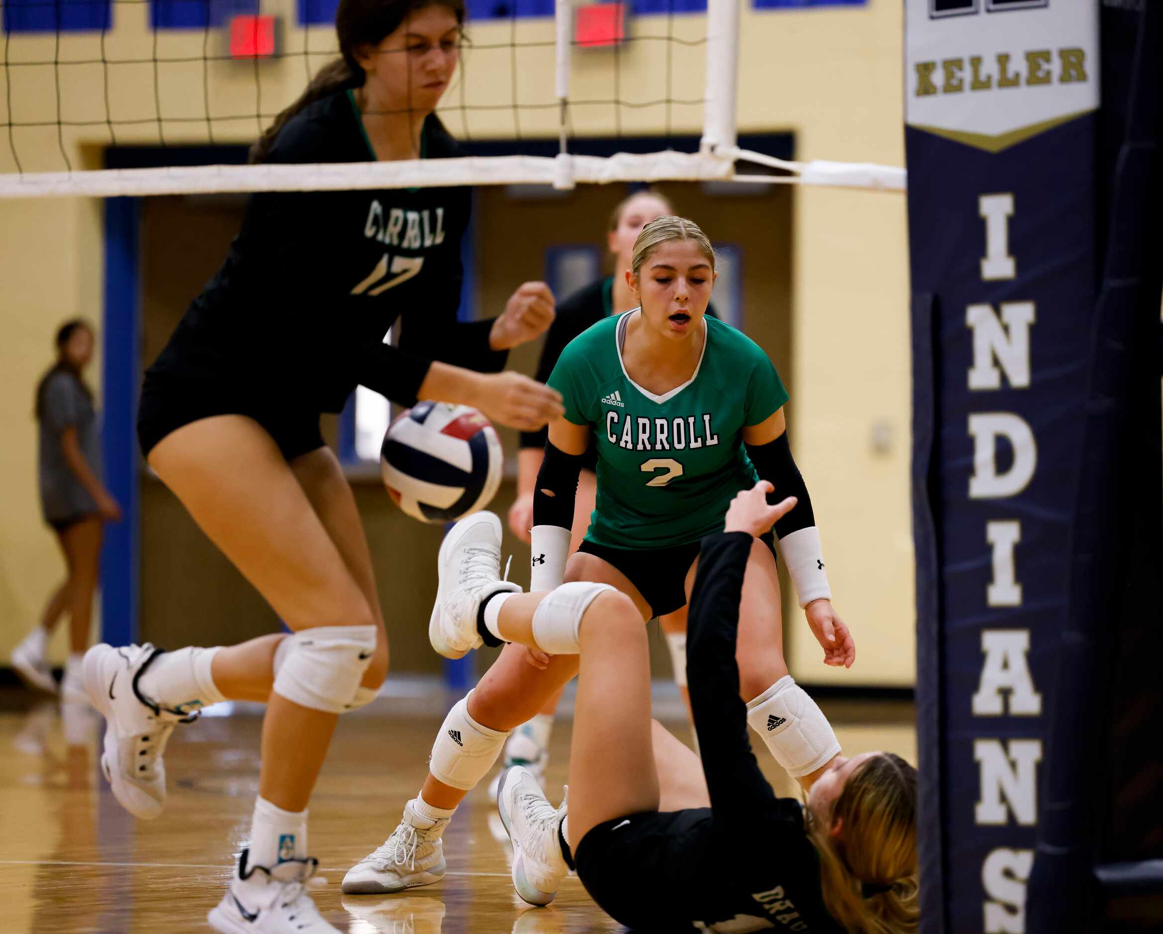 Southlake Carroll’s Brooklyn Harter (11) falls after failing to hit the ball against Keller...
