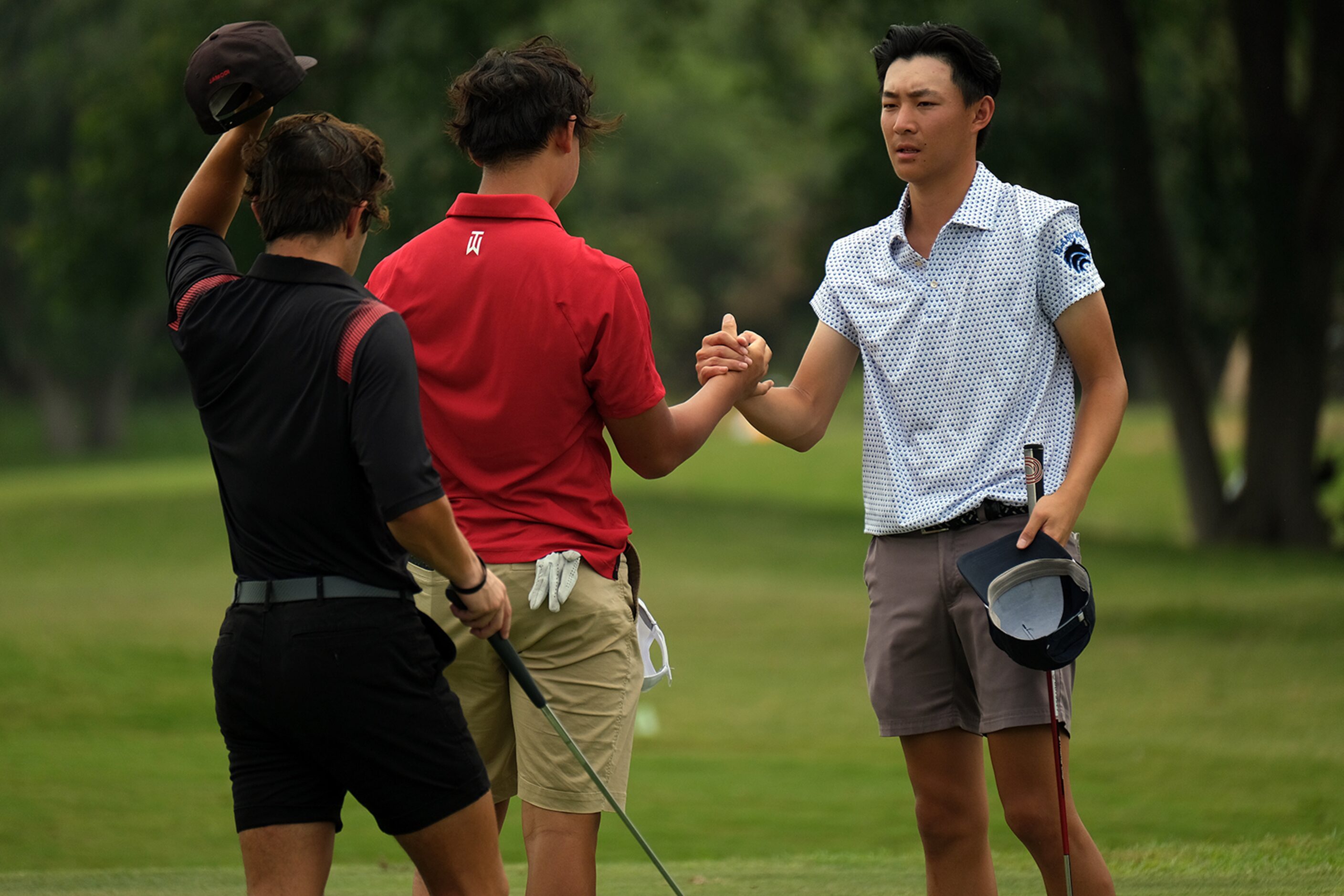 Ethan Fang of Plano West congratulates the golfers in his group after play during Day 2 of...