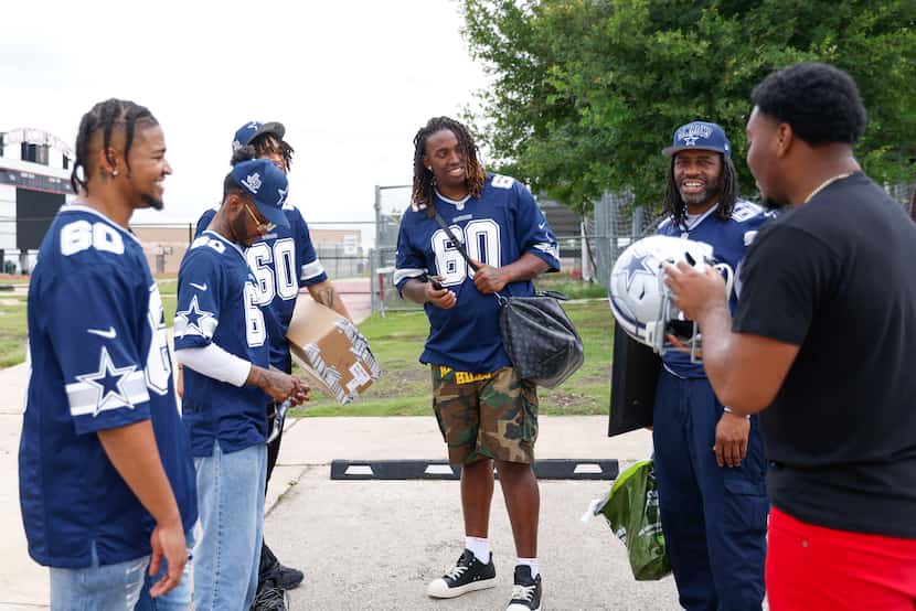 Dallas Cowboys left tackle Tyler Guyton (center) with his family wait for his ride following...
