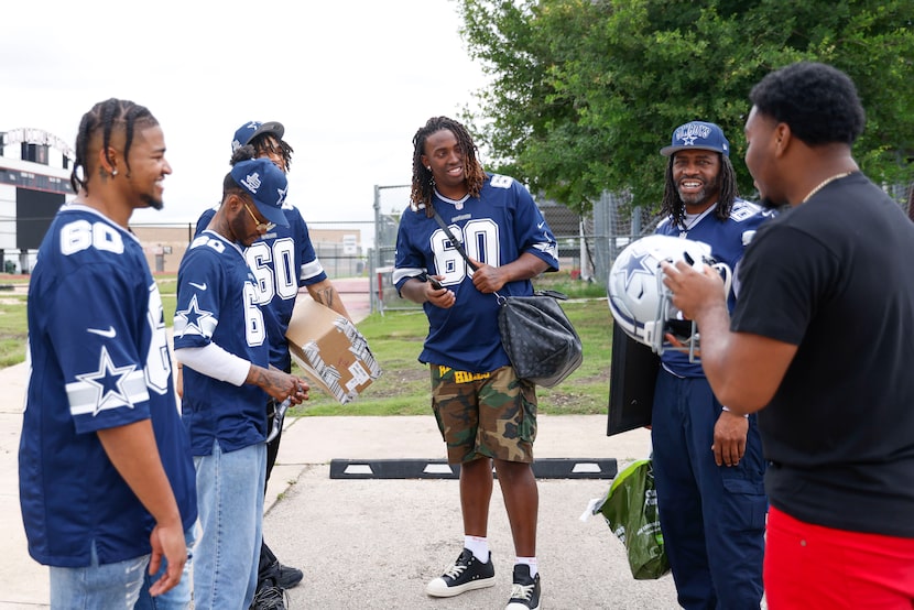 Dallas Cowboys left tackle Tyler Guyton (center) waited with his family for his ride...