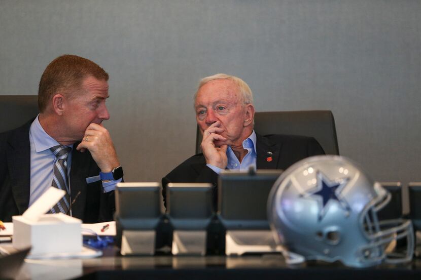 Dallas Cowboys head coach Jason Garrett, left, and Owner Jerry Jones, talk at head the table...
