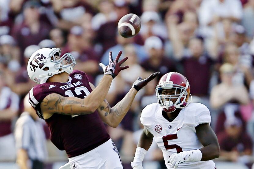 Texas AM Aggies wide receiver Mike Evans (13) stays ahead of Alabama defensive back Cyrus...