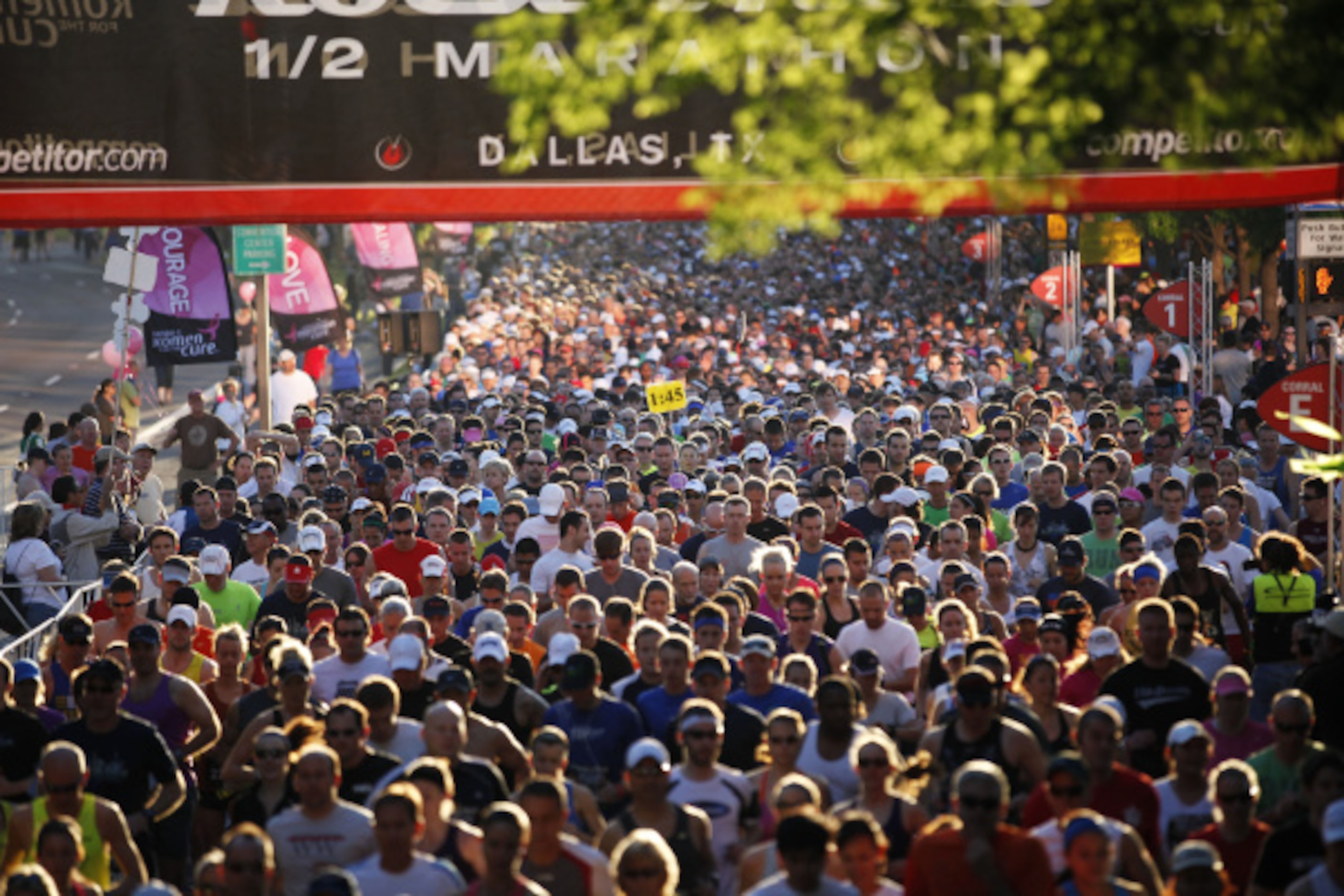 Running participants make their way down Young Street during Dallas Rock 'N' Roll half...