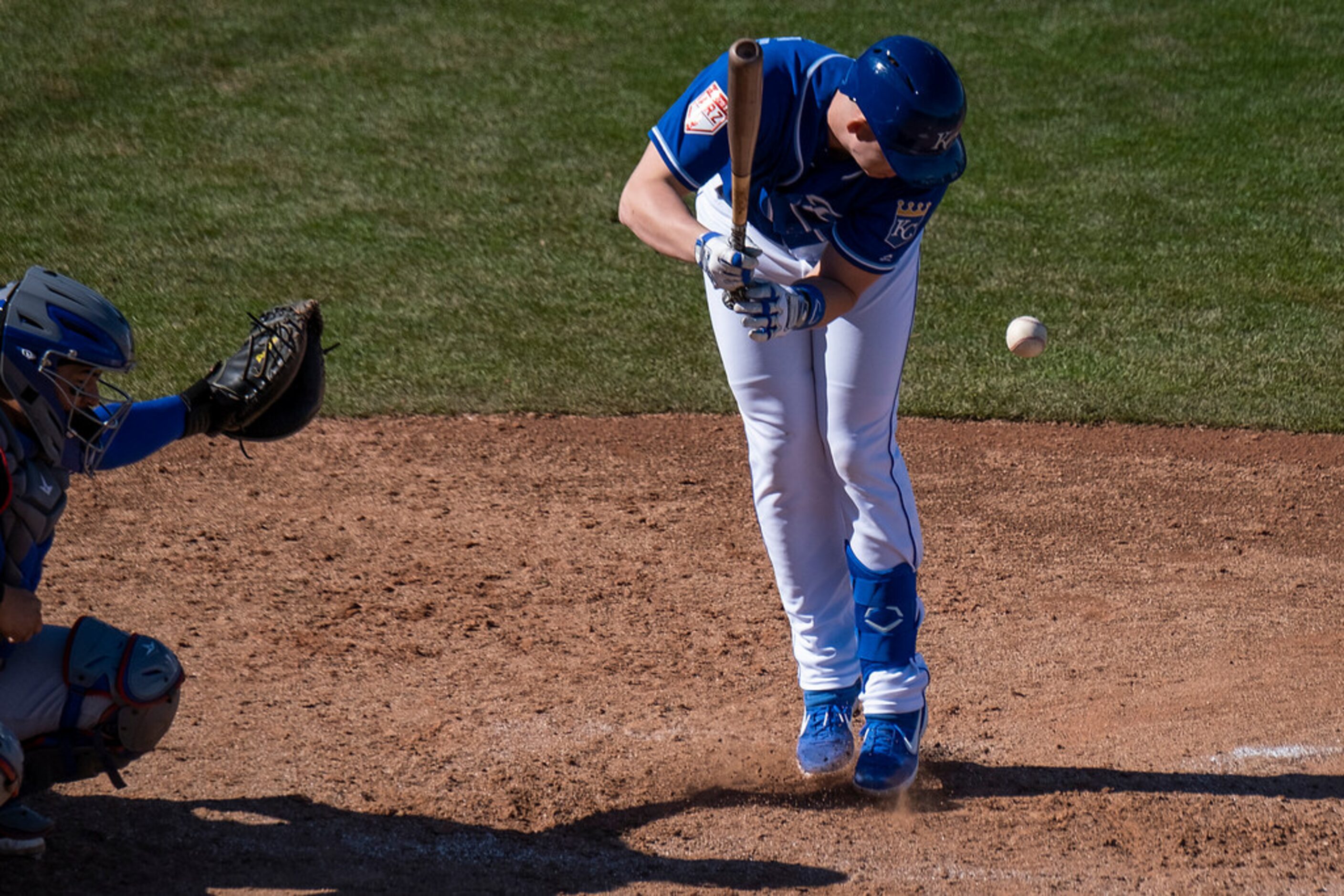 Kansas City Royals first baseman Frank Schwindel is hit by a pitch from pitcher Michael...