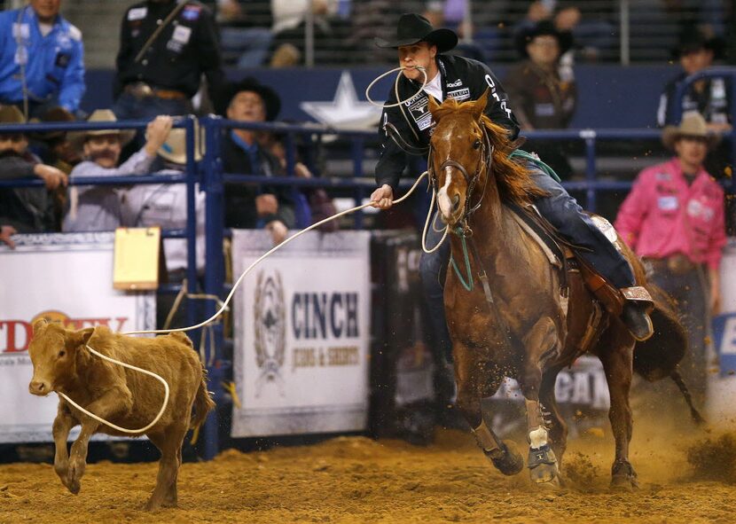 Timber Moore lassos a calf during The American rodeo. (Tom Fox/The Dallas Morning News)