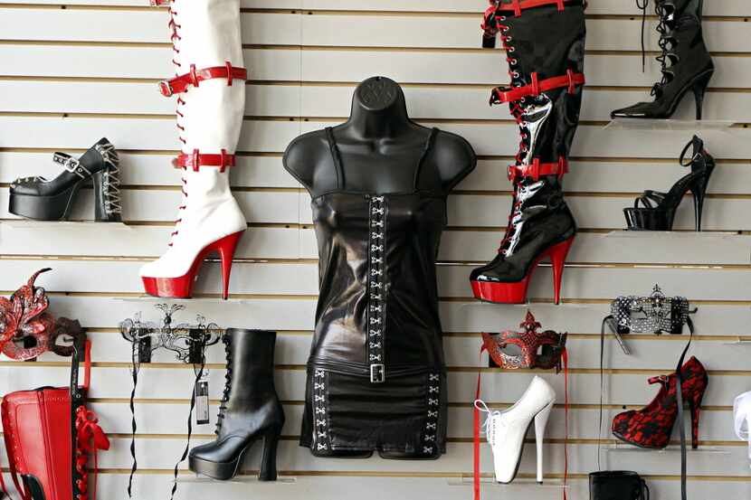 High-heeled and platform boots line a wall display at a Sara's Secret store in North Dallas....