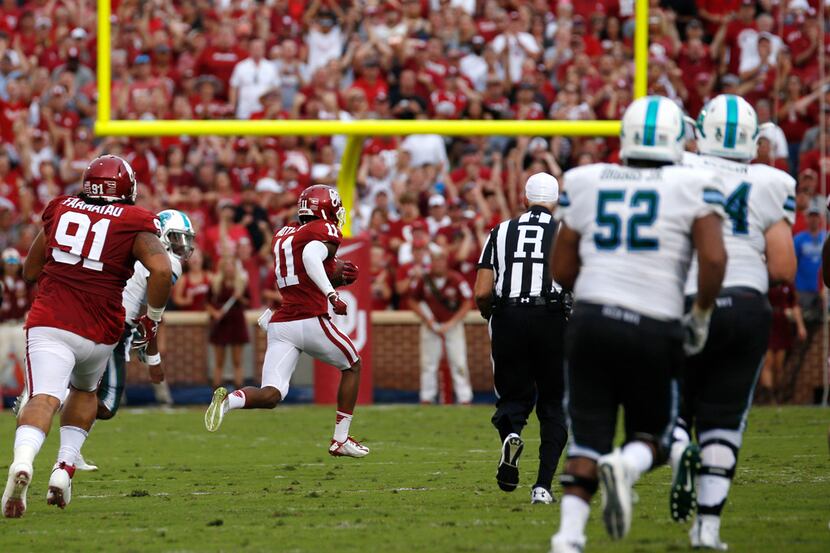 Oklahoma cornerback Parnell Motley (11) returns a interception for a touchdown against...