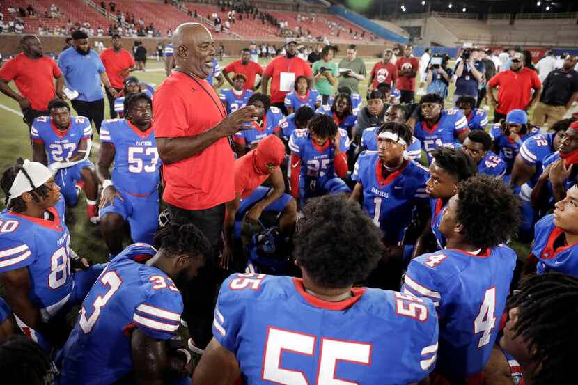 Duncanville head coach Reginald Samples (left) speaks to his team following their opening...