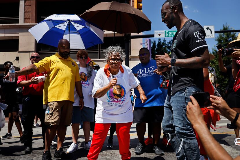During her walk through downtown Fort Worth, Opal Lee (center) stopped in the middle of...