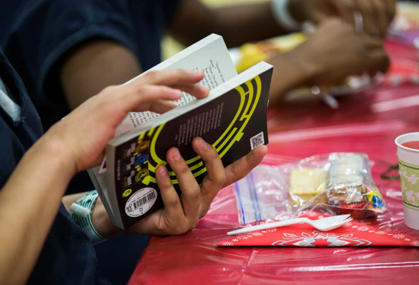 A juvenile inmate looks at a book he received at the lunch provided by JuviGap. (Ashley...