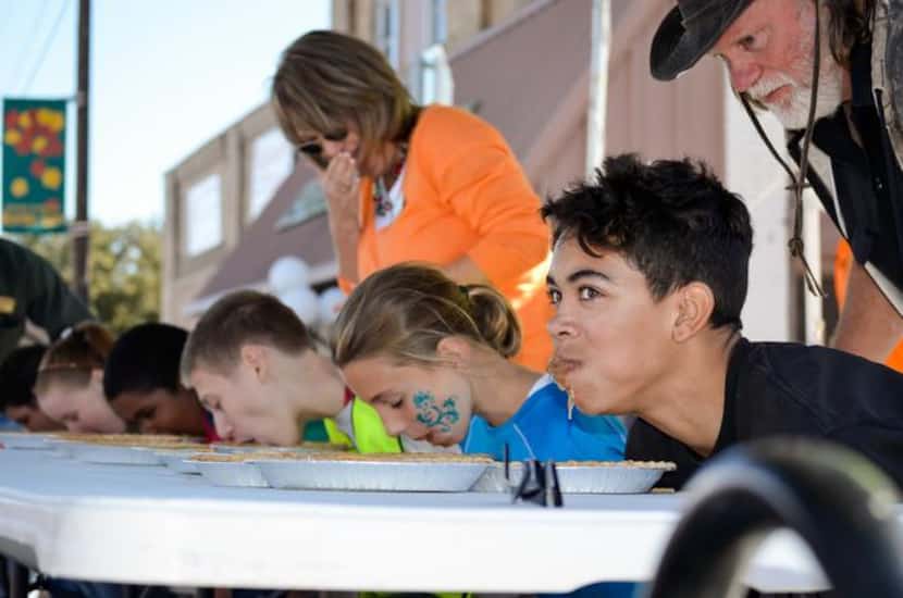 
Kids rushed to stuff their faces during a pie-eating contest at last year’s FunFest. 

