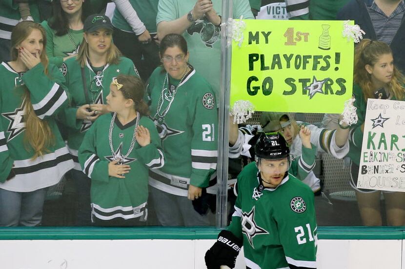Dallas Stars left wing Antoine Roussel (21) skates past fans during warmups before Game 2 of...