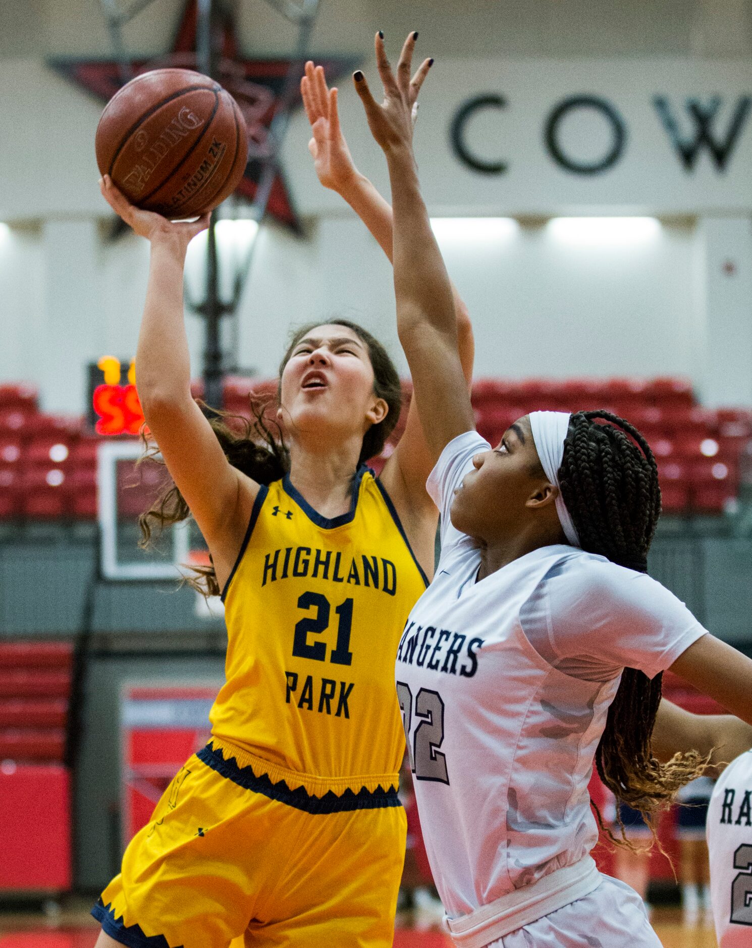 Highland Park post Alianne Elmore (21) goes up for a shot against forward Victoria Gooden...