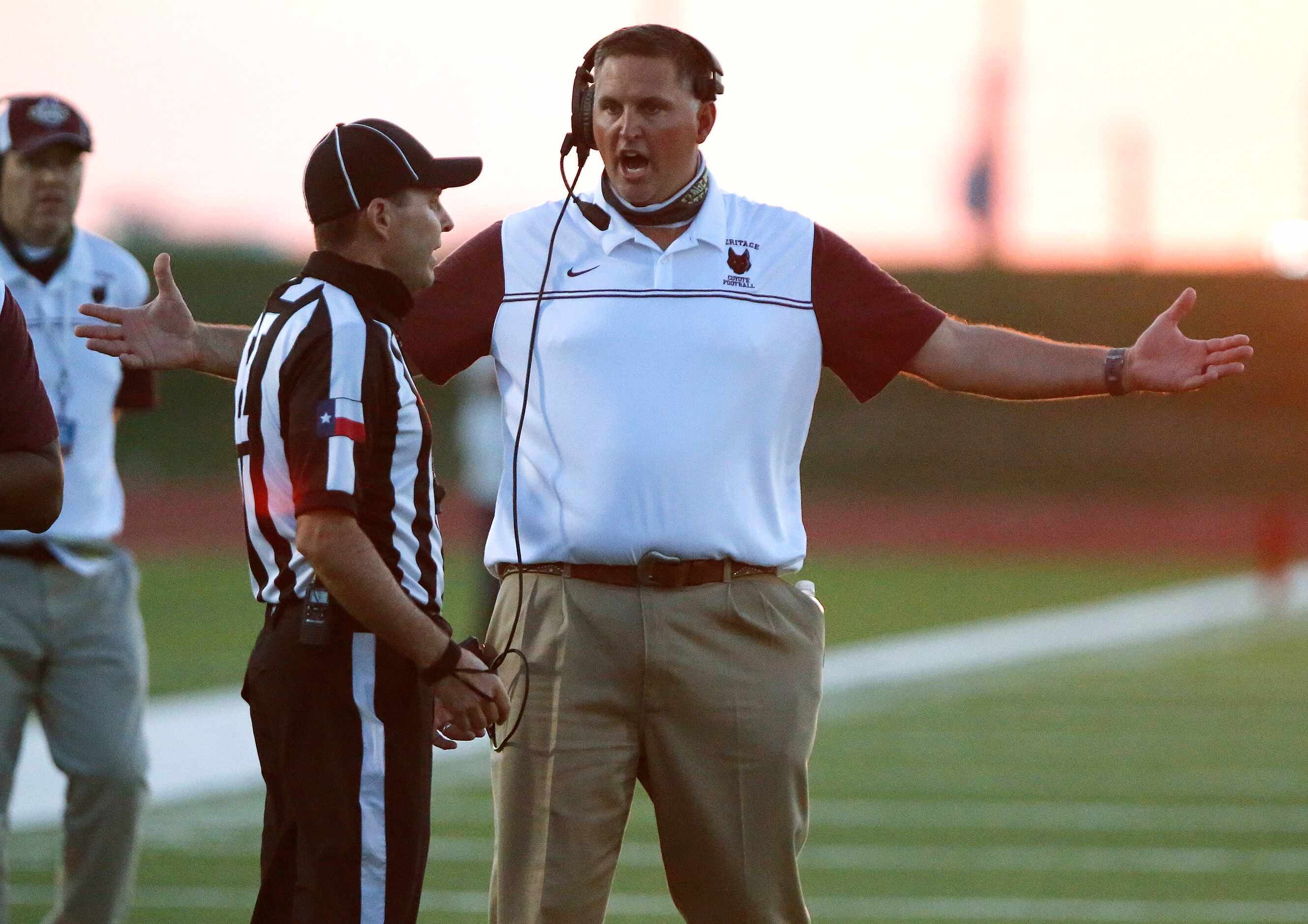 Heritage High School head coach Kenneth Gilchrist questions a call during the first quarter...