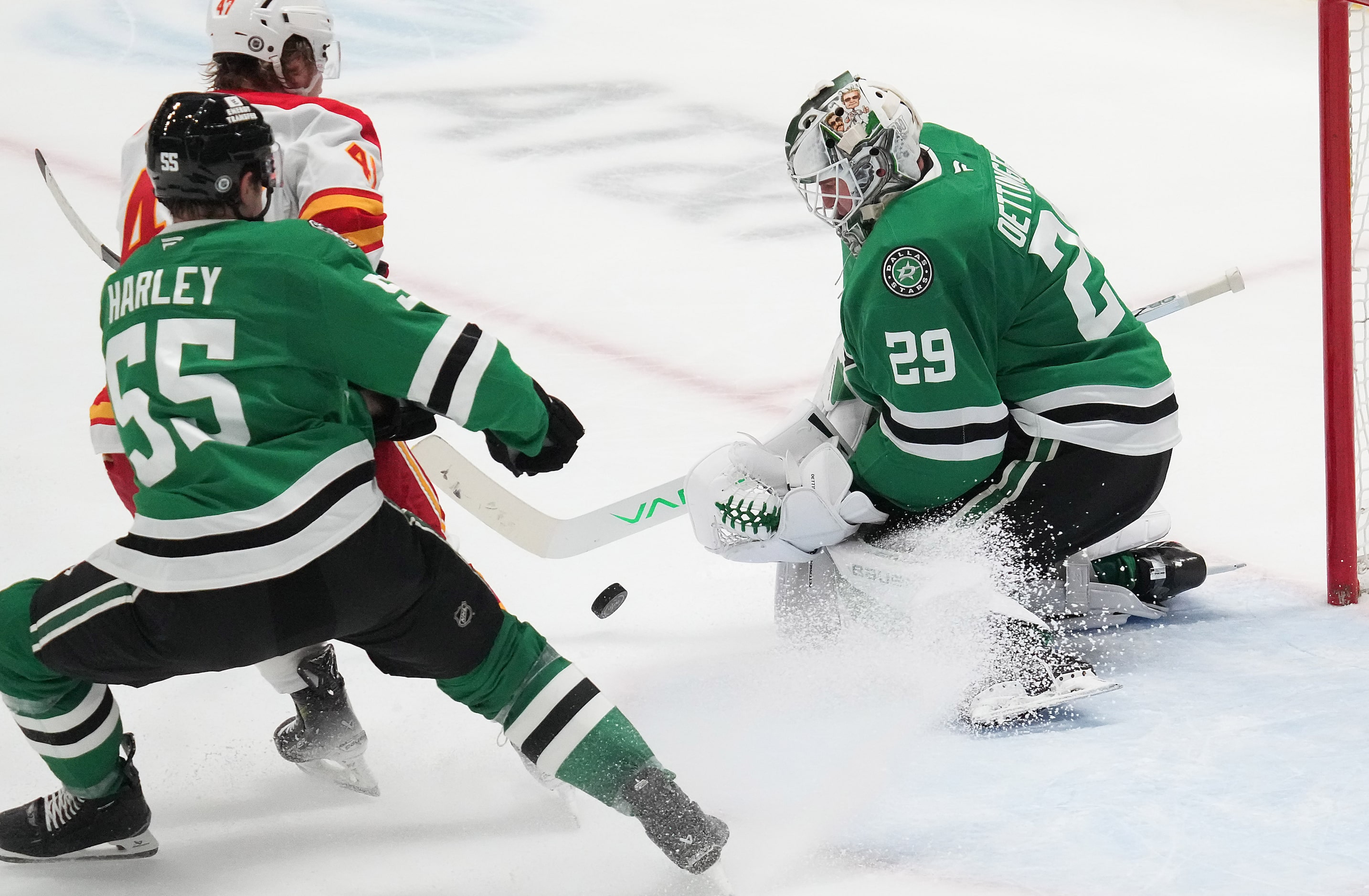 Dallas Stars goaltender Jake Oettinger (29) makes a save against Calgary Flames center...