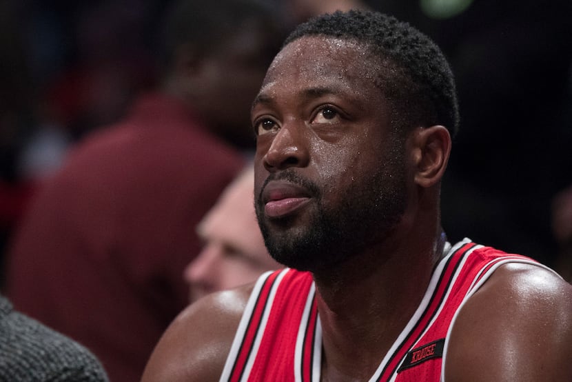Chicago Bulls guard Dwyane Wade watches game action from the bench during the first half of...