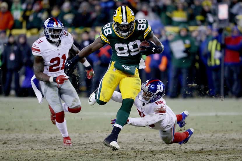 GREEN BAY, WI - JANUARY 8:  Ty Montgomery #88 of the Green Bay Packers escapes a tackle...