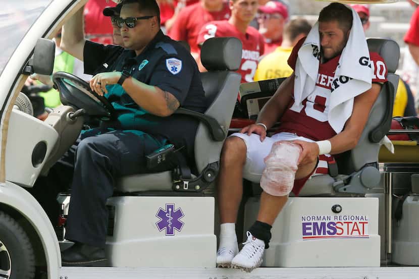 Oklahoma quarterback Austin Kendall (10) is driven off the field after an injury in the...
