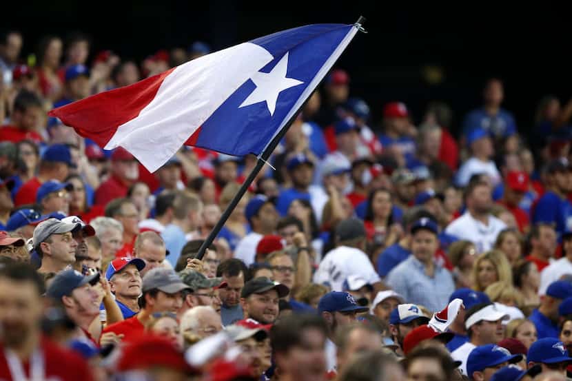  A Texas Rangers fan waves the state flag during their ALDS Series game against the Toronto...