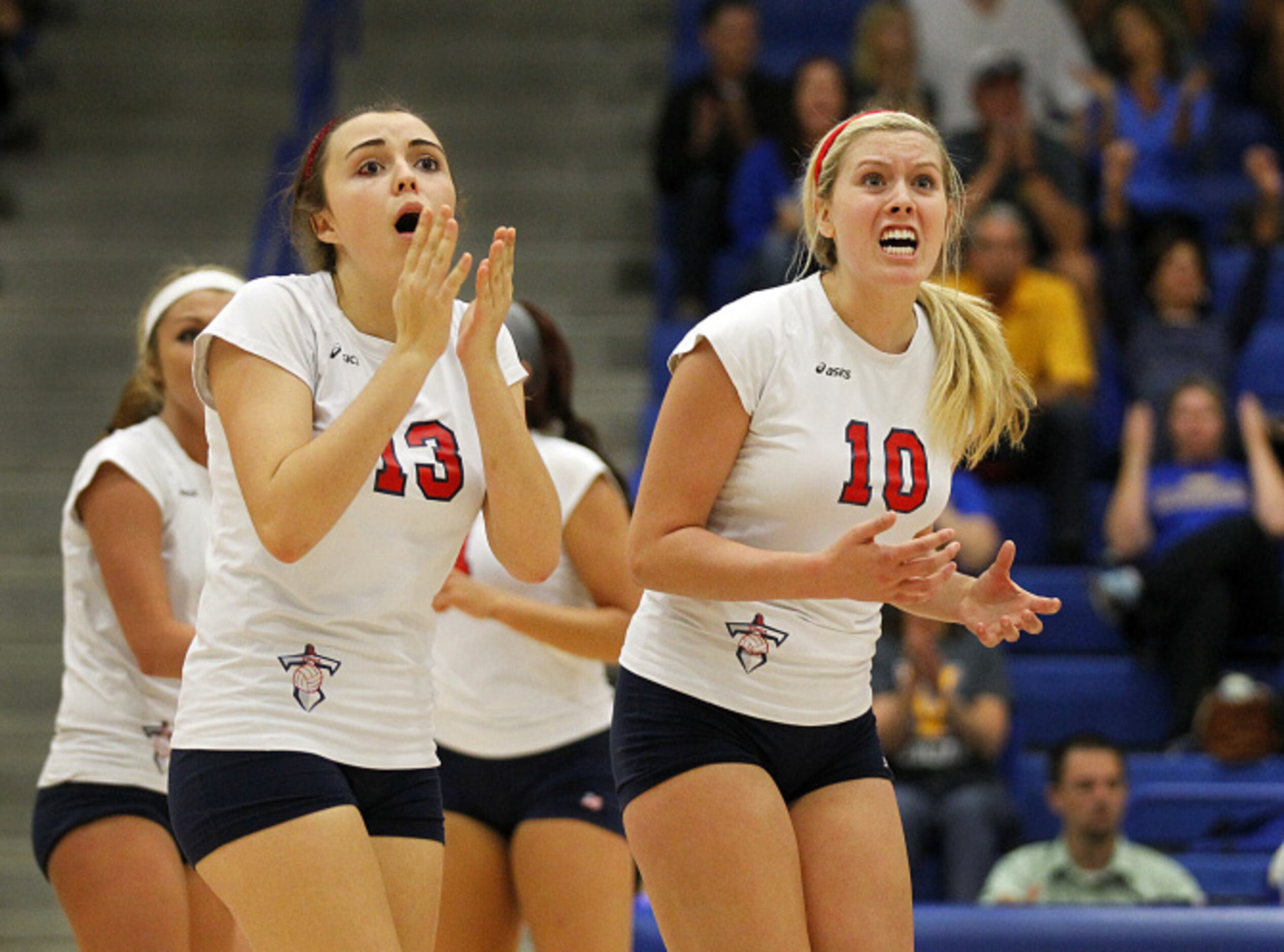 Frisco Centennial's Cydney Sutherland (13) and Lexi MacLean (10) are surprised by  the...