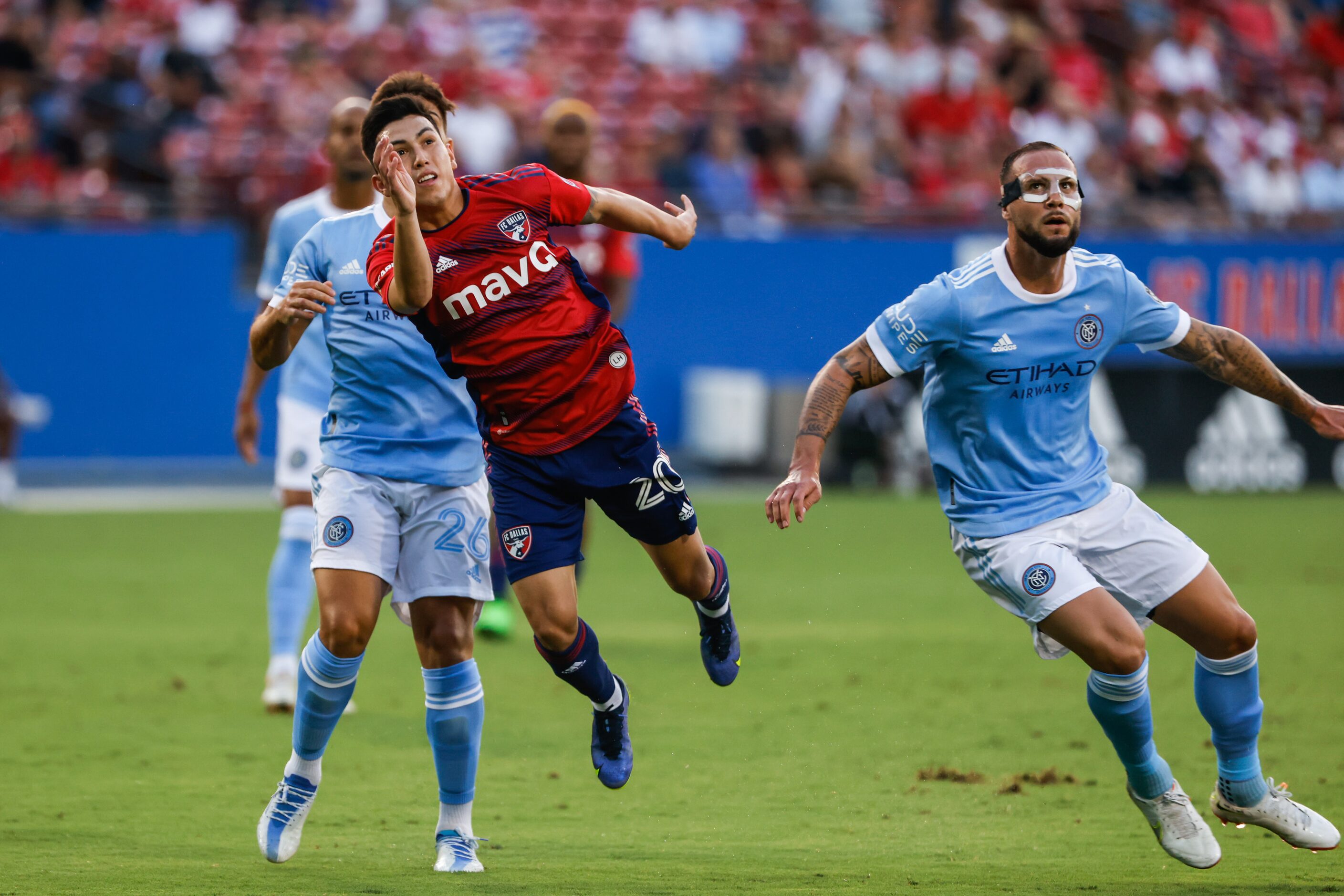 FC Dallas forward Alan Velasco (20), New York City midfielder Nicolás Acevedo (26) and...