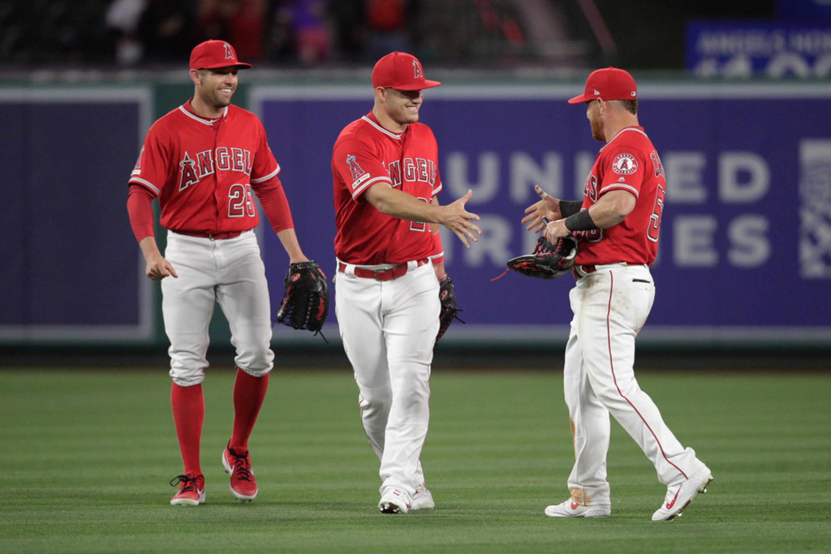 Los Angeles Angels' Peter Bourjos, Mike Trout and Kole Calhoun, from left, celebrate the...