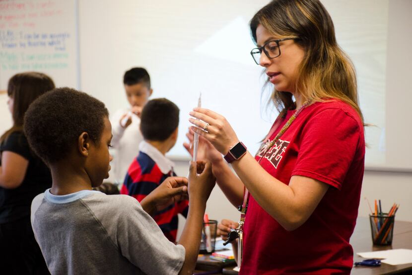 Livier Alcala, a second-grade bilingual teacher at Hodge Elementary in Denton ISD, helps...