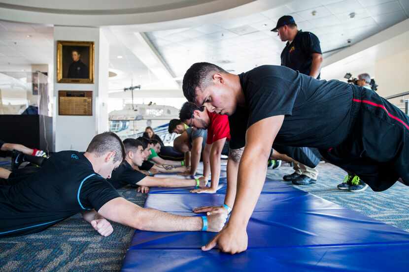 Officer applicants Ross Harbor (left) and Tony Hinojosa do push-ups during on-site testing...