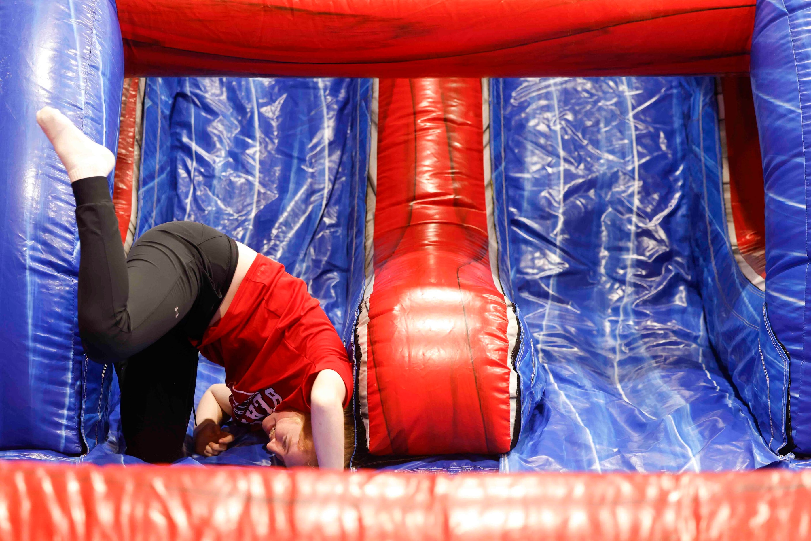 Sophomore Caroline Stewart reacts while rolling down an inflatable slide during the 150th...