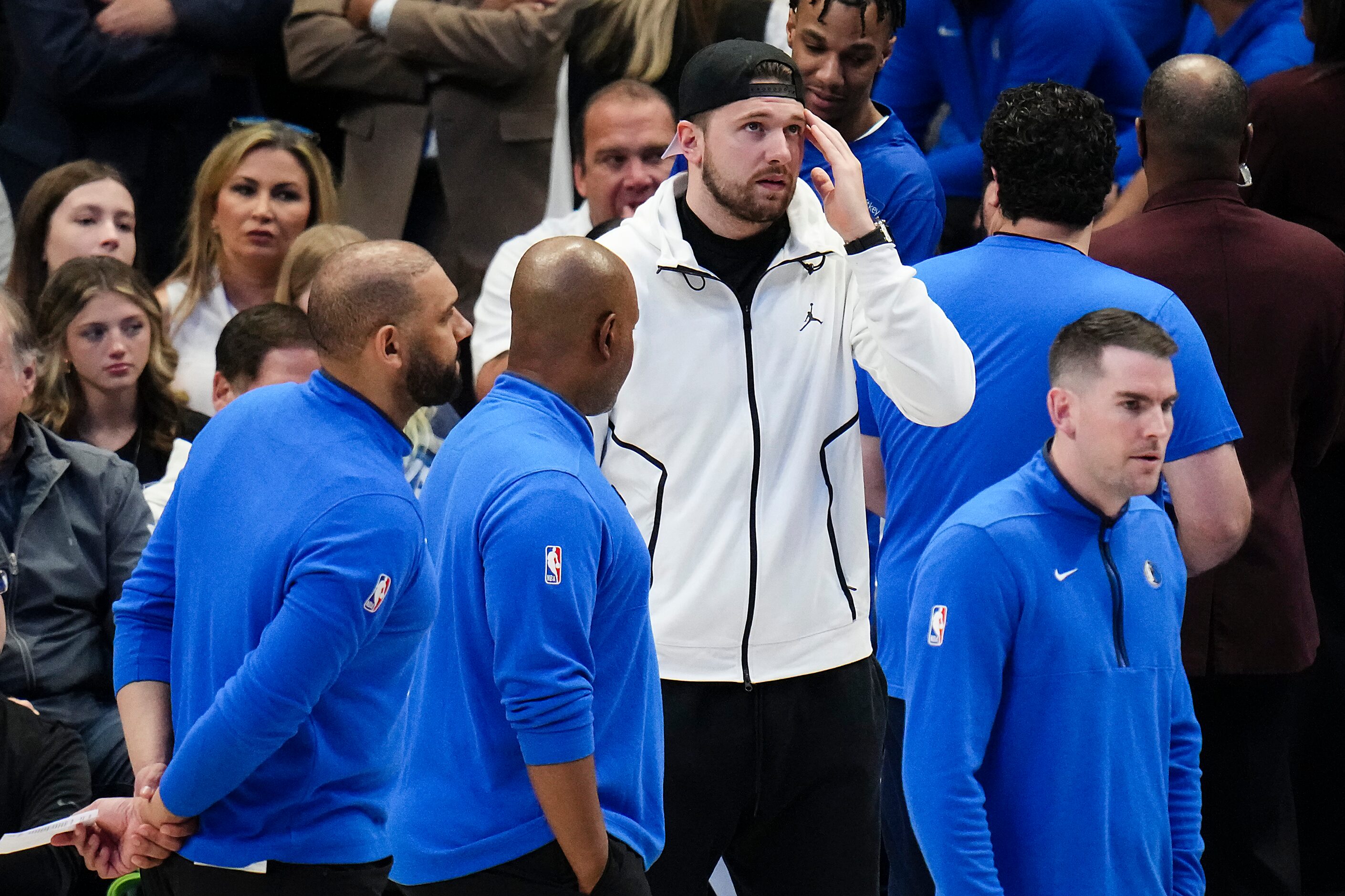 Dallas Mavericks guard Luka Doncic watches from the bench during the first half of an NBA...