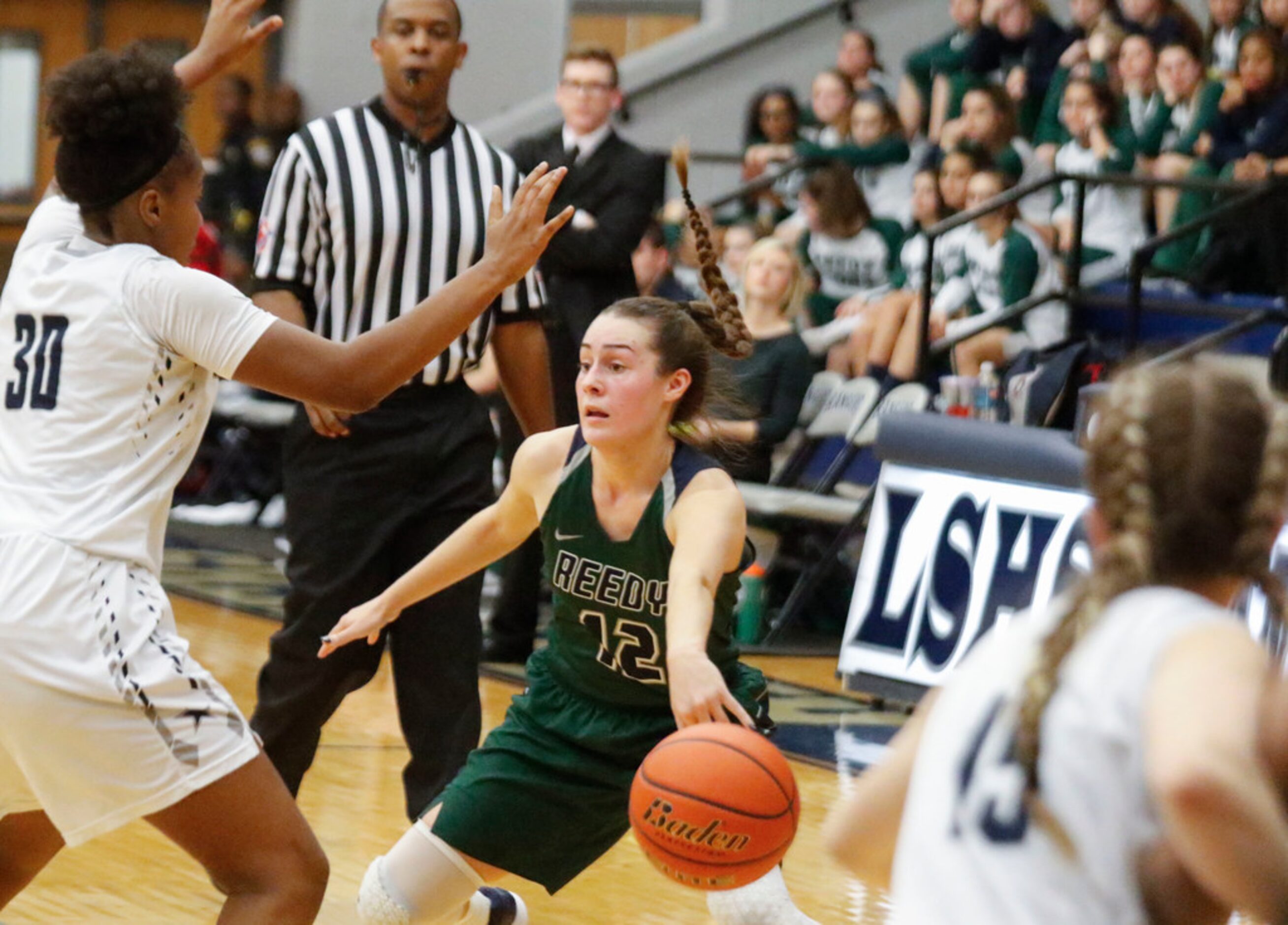 Frisco Reedy's Christina Mason (12) passes the ball between Frisco Lone Star's Kayla...