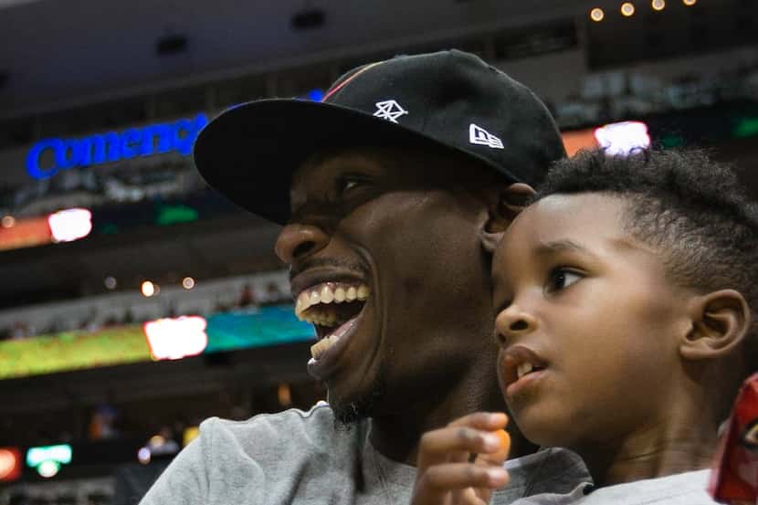 Josh Howard and his son watch the Big 3 Basketball Tournament at the American Airlines...