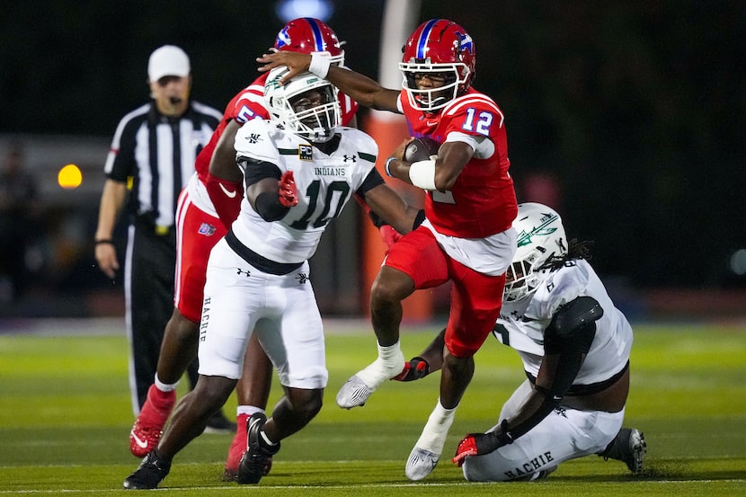 Duncanville quarterback Keelon Russell (12) pushes past Waxahachie defensive lineman Cade...