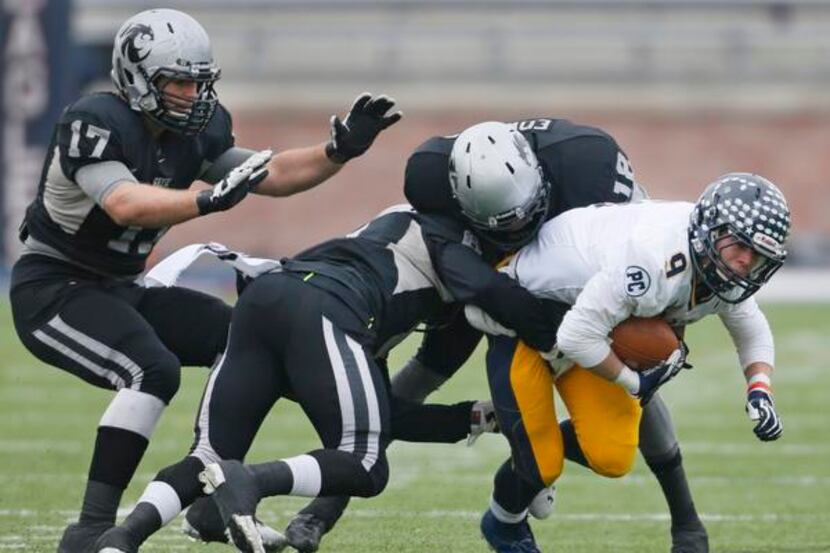 
Highland Park’s Remy Kell (9) fights for yardage during the Highland Park High School Scots...