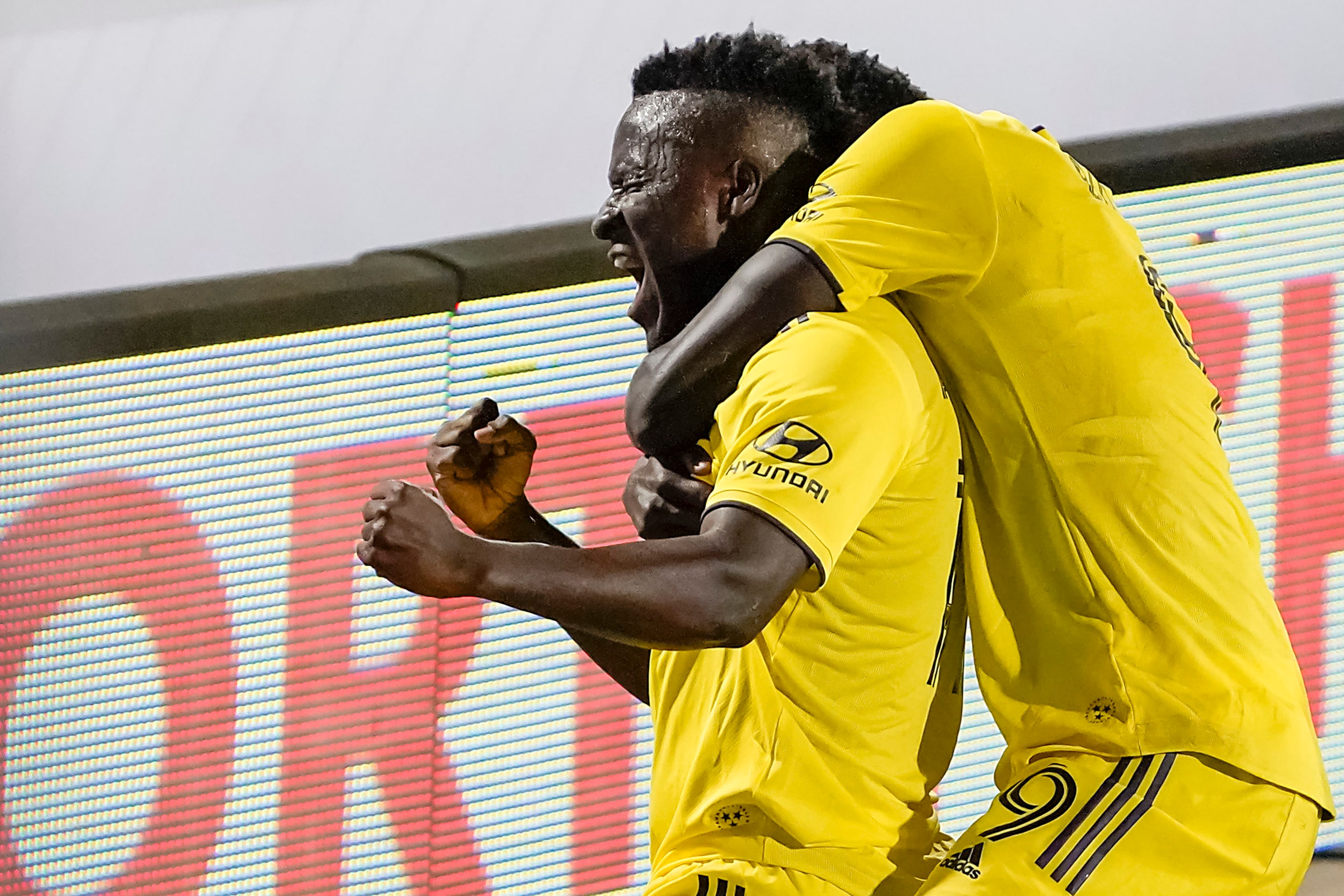 Nashville SC forward David Accam (11) celebrates with forward Dominique Badji (9) after...